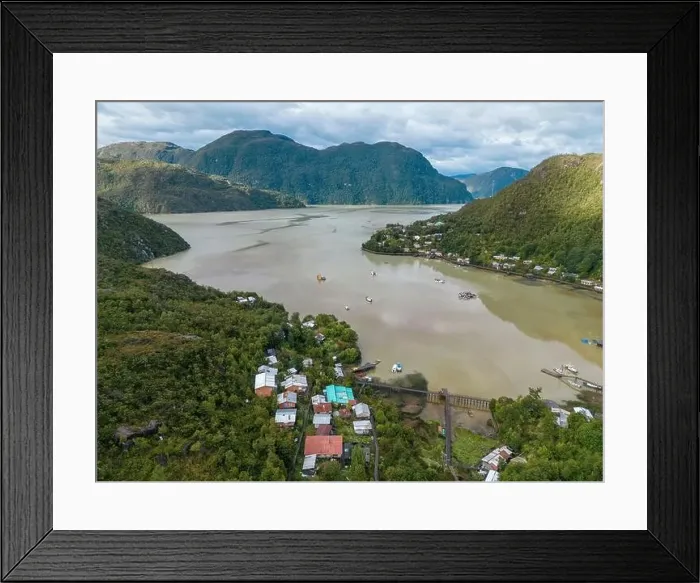 Framed Print : Drone view of Caleta Tortel with its small cabins - Discovering the beautiful village while traveling the Carretera Framed Print : Drone view of Caleta Tortel with its small cabins - Discovering the beautiful village while traveling the Carretera