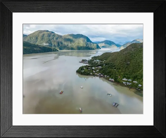 Framed Print : Drone view of Caleta Tortel with its small cabins - Discovering the beautiful village while traveling the Carretera Framed Print : Drone view of Caleta Tortel with its small cabins - Discovering the beautiful village while traveling the Carretera