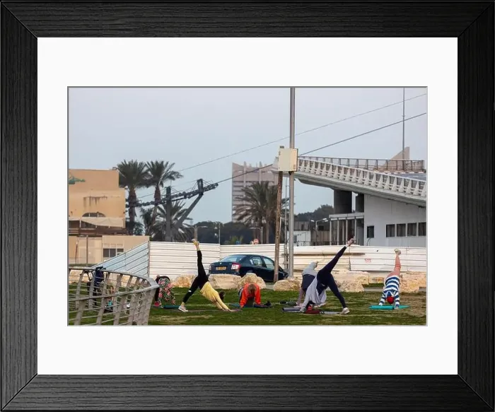 Framed Print : Haifa, Israel - March 1, 2023, Promenade along the sea. Women do yoga and sports near the beach in Haifa Framed Print : Haifa, Israel - March 1, 2023, Promenade along the sea. Women do yoga and sports near the beach in Haifa