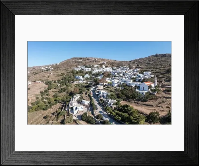 Framed Print : Cyclades, Greece. Tinos Greek island, aerial drone view of Kardiani village town, white color buildings, cloudy blue sky Framed Print : Cyclades, Greece. Tinos Greek island, aerial drone view of Kardiani village town, white color buildings, cloudy blue sky
