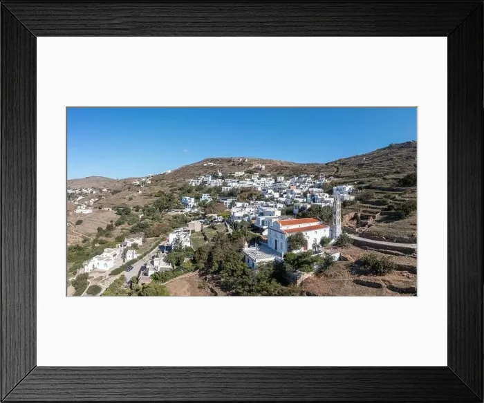 Framed Print : Cyclades, Greece. Tinos Greek island, aerial drone view of Kardiani village town, white color buildings, cloudy blue sky Framed Print : Cyclades, Greece. Tinos Greek island, aerial drone view of Kardiani village town, white color buildings, cloudy blue sky