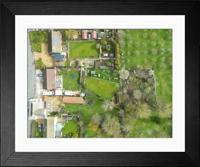 Framed Print : Top down view of a mixture of old and modern houses and bungalows seen at the edge of an East Anglian village Framed Print : Top down view of a mixture of old and modern houses and bungalows seen at the edge of an East Anglian village