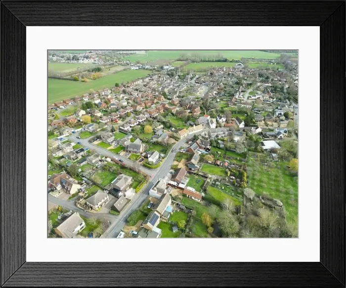 Framed Print : Drone view of a sprawling East Anglian village showing the main roadway leading through the bottom left of the image Framed Print : Drone view of a sprawling East Anglian village showing the main roadway leading through the bottom left of the image