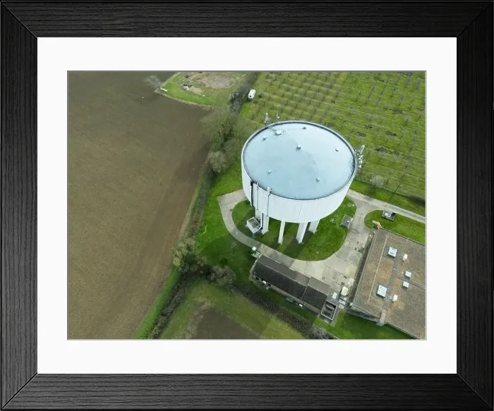 Framed Print : Aerial view of a large concrete water tower seen next to a large shed which houses chickens Framed Print : Aerial view of a large concrete water tower seen next to a large shed which houses chickens