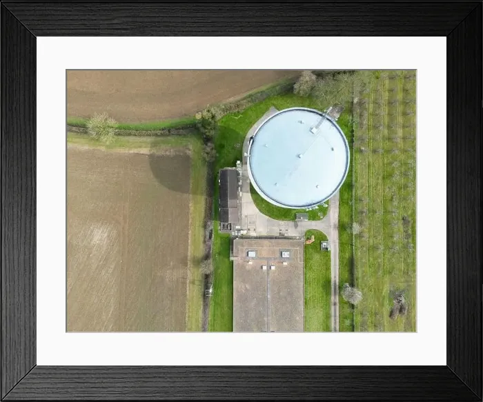 Framed Print : Aerial, top down view of a large water tower seen at the edge of a large shed which houses chickens Framed Print : Aerial, top down view of a large water tower seen at the edge of a large shed which houses chickens