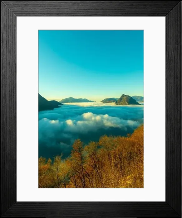 Framed Print : Mountain Peak San Salvatore Above Cloudscape with a Autumn Tree and Sunlight with Clear Sky in Lugano Framed Print : Mountain Peak San Salvatore Above Cloudscape with a Autumn Tree and Sunlight with Clear Sky in Lugano