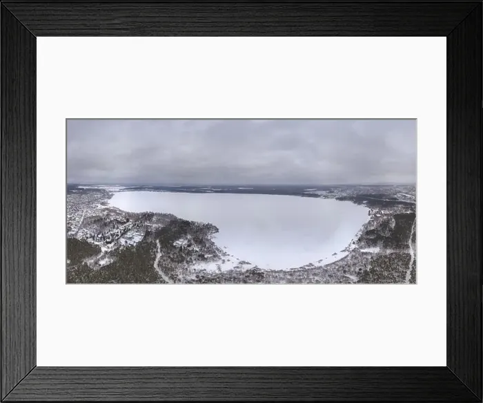 Framed Print : Snow-covered forest on lake shore with ice at sunset and the city on horizon Framed Print : Snow-covered forest on lake shore with ice at sunset and the city on horizon