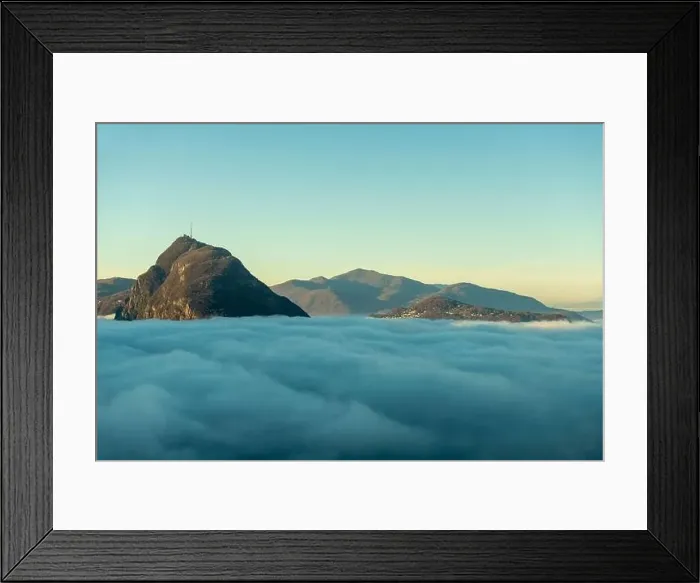 Framed Print : Mountain Peak San Salvatore Above Cloudscape with Sunlight and Clear Sky in Lugano, Ticino in Switzerland Framed Print : Mountain Peak San Salvatore Above Cloudscape with Sunlight and Clear Sky in Lugano, Ticino in Switzerland