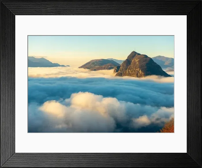 Framed Print : Mountain Peak San Salvatore Above Cloudscape with a Autumn Tree and Sunlight with Clear Sky in Lugano Framed Print : Mountain Peak San Salvatore Above Cloudscape with a Autumn Tree and Sunlight with Clear Sky in Lugano