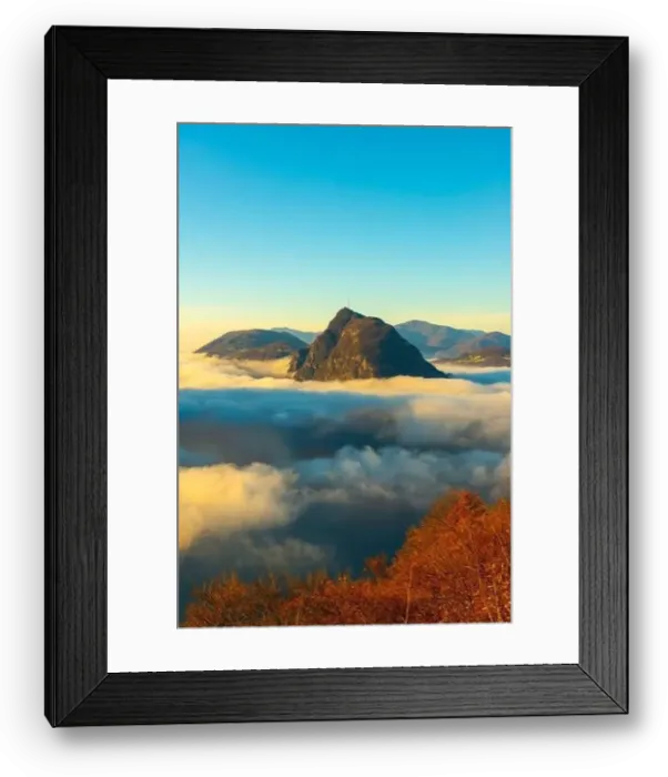 Framed Print : Mountain Peak San Salvatore Above Cloudscape with a Autumn Tree and Sunlight with Clear Sky in Lugano Framed Print : Mountain Peak San Salvatore Above Cloudscape with a Autumn Tree and Sunlight with Clear Sky in Lugano