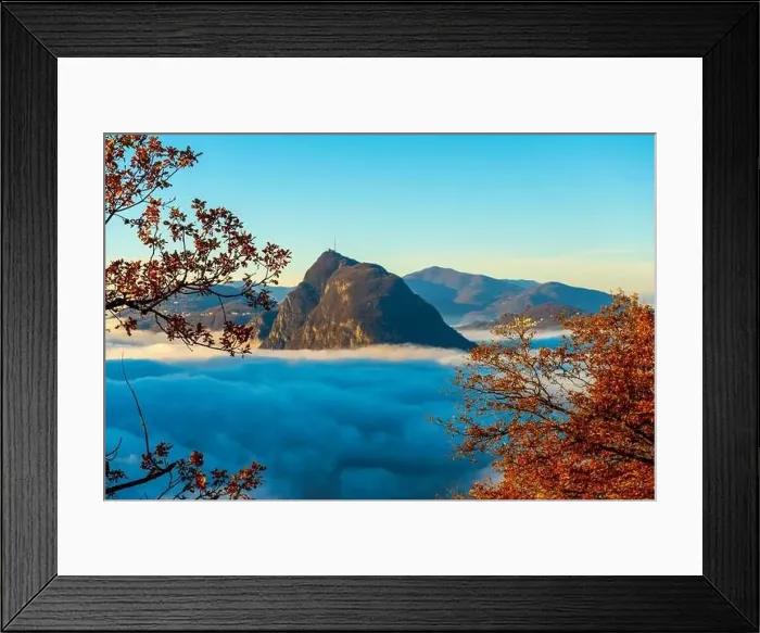 Framed Print : Mountain Peak San Salvatore Above Cloudscape with a Autumn Tree and Sunlight with Clear Sky in Lugano Framed Print : Mountain Peak San Salvatore Above Cloudscape with a Autumn Tree and Sunlight with Clear Sky in Lugano