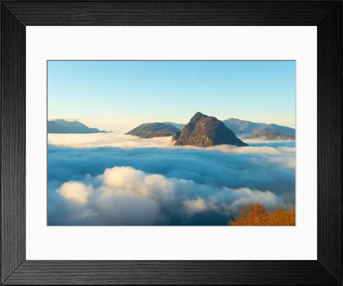 Framed Print : Mountain Peak San Salvatore Above Cloudscape with a Autumn Tree and Sunlight with Clear Sky in Lugano Framed Print : Mountain Peak San Salvatore Above Cloudscape with a Autumn Tree and Sunlight with Clear Sky in Lugano