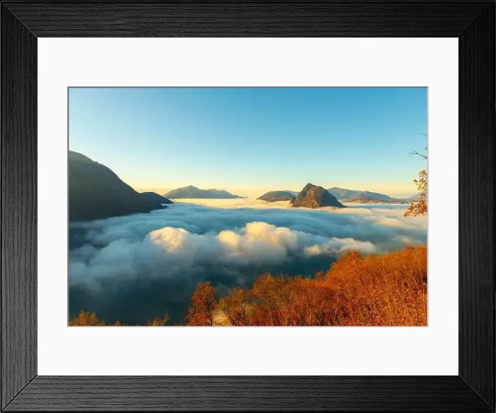 Framed Print : Mountain Peak San Salvatore Above Cloudscape with a Autumn Tree and Sunlight with Clear Sky in Lugano Framed Print : Mountain Peak San Salvatore Above Cloudscape with a Autumn Tree and Sunlight with Clear Sky in Lugano