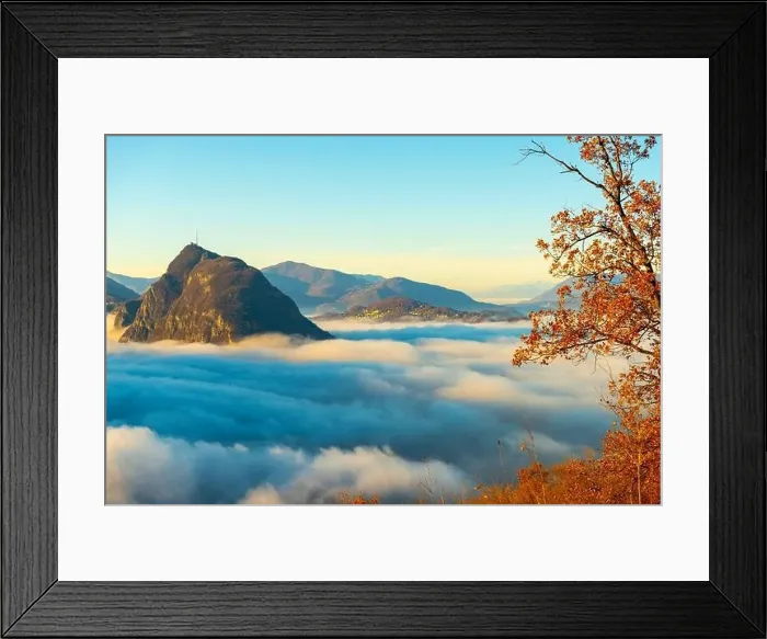 Framed Print : Mountain Peak San Salvatore Above Cloudscape with a Autumn Tree and Sunlight with Clear Sky in Lugano Framed Print : Mountain Peak San Salvatore Above Cloudscape with a Autumn Tree and Sunlight with Clear Sky in Lugano