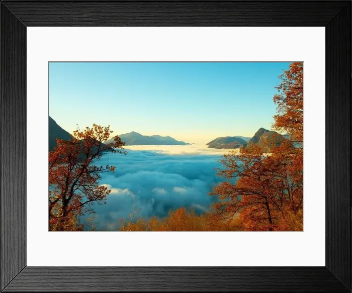 Framed Print : Mountain Peak San Salvatore Above Cloudscape with a Autumn Tree and Sunlight with Clear Sky in Lugano Framed Print : Mountain Peak San Salvatore Above Cloudscape with a Autumn Tree and Sunlight with Clear Sky in Lugano