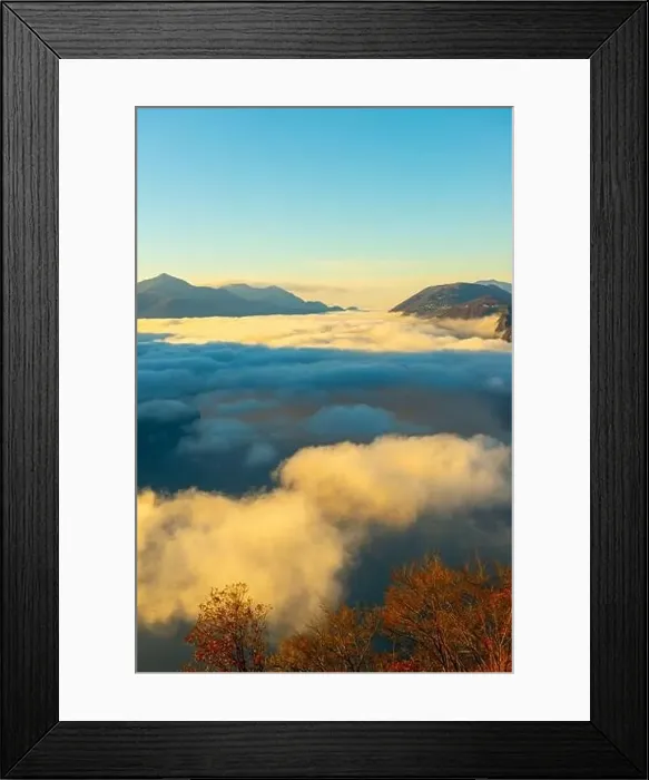 Framed Print : Mountain Peak Above Cloudscape with Sunlight and Clear Sky in Lugano, Ticino in Switzerland Framed Print : Mountain Peak Above Cloudscape with Sunlight and Clear Sky in Lugano, Ticino in Switzerland