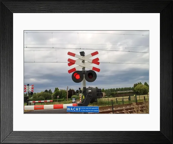 Framed Print : Barriers and red lights at railroad crossing in Moordrecht in the Netherlands Framed Print : Barriers and red lights at railroad crossing in Moordrecht in the Netherlands