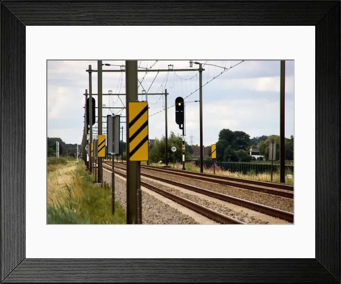 Framed Print : Barriers and red lights at railroad crossing in Moordrecht in the Netherlands