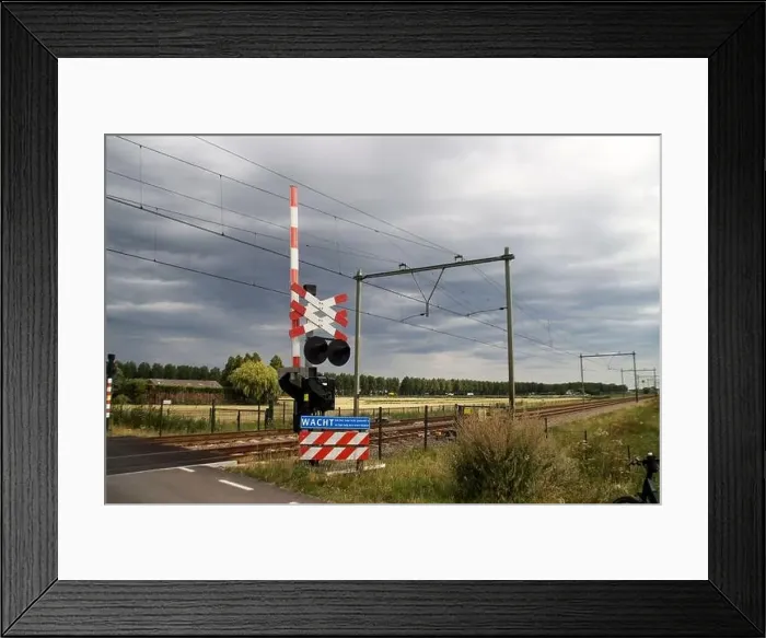Framed Print : Barriers and red lights at railroad crossing in Moordrecht in the Netherlands Framed Print : Barriers and red lights at railroad crossing in Moordrecht in the Netherlands