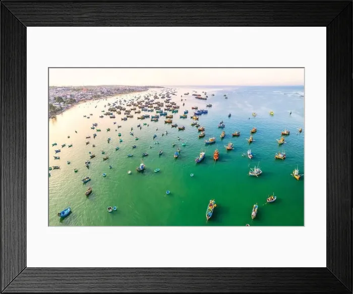 Framed Print : Aerial view of Mui Ne fishing village in the morning with hundreds of boats anchored to avoid storms Framed Print : Aerial view of Mui Ne fishing village in the morning with hundreds of boats anchored to avoid storms