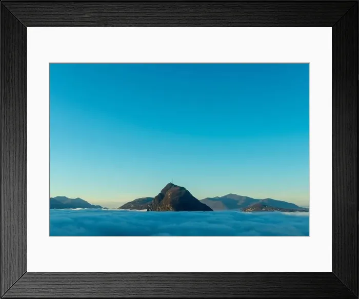 Framed Print : Mountain Peak San Salvatore Above Cloudscape with Sunlight and Clear Sky in Lugano, Ticino in Switzerland Framed Print : Mountain Peak San Salvatore Above Cloudscape with Sunlight and Clear Sky in Lugano, Ticino in Switzerland