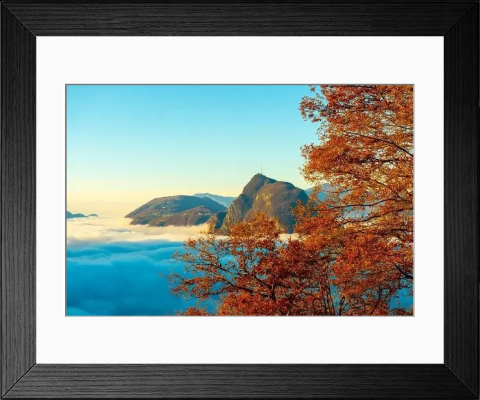 Framed Print : Mountain Peak San Salvatore Above Cloudscape with a Autumn Tree and Sunlight with Clear Sky in Lugano Framed Print : Mountain Peak San Salvatore Above Cloudscape with a Autumn Tree and Sunlight with Clear Sky in Lugano