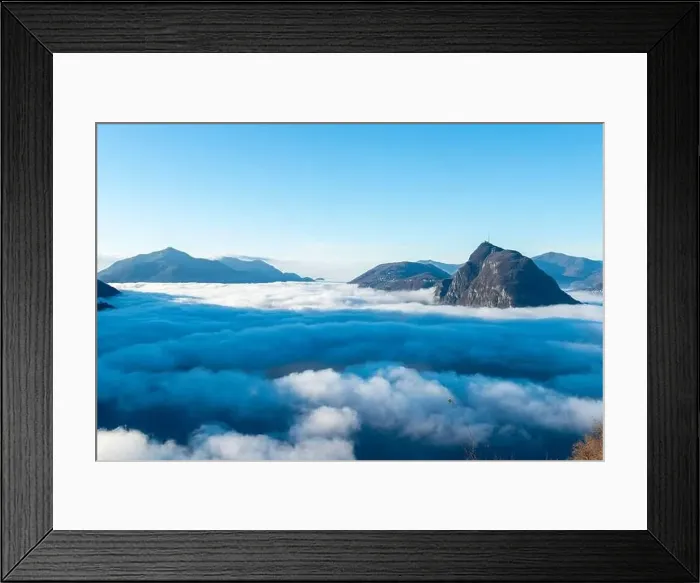 Framed Print : Mountain Peak San Salvatore Above Cloudscape with a Autumn Tree and Sunlight with Clear Sky in Lugano Framed Print : Mountain Peak San Salvatore Above Cloudscape with a Autumn Tree and Sunlight with Clear Sky in Lugano