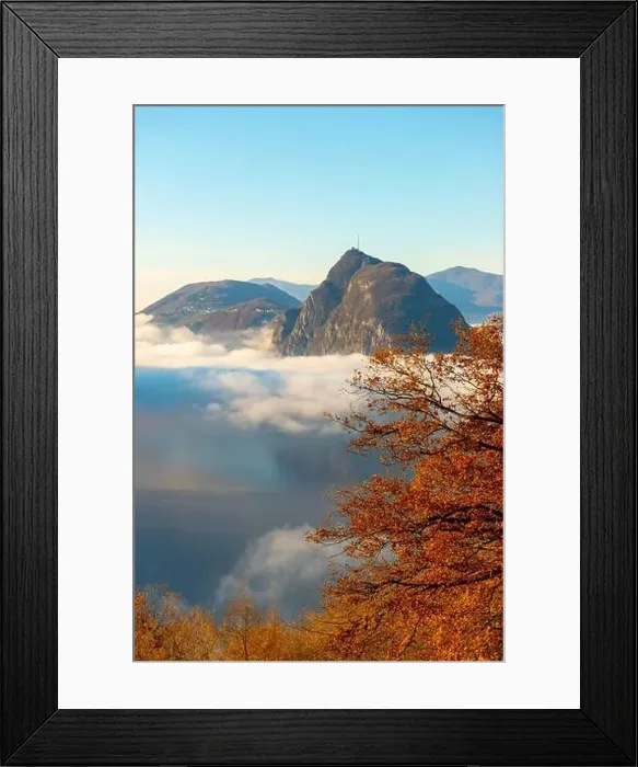 Framed Print : Mountain Peak San Salvatore Above Cloudscape with a Autumn Tree and Sunlight with Clear Sky in Lugano Framed Print : Mountain Peak San Salvatore Above Cloudscape with a Autumn Tree and Sunlight with Clear Sky in Lugano