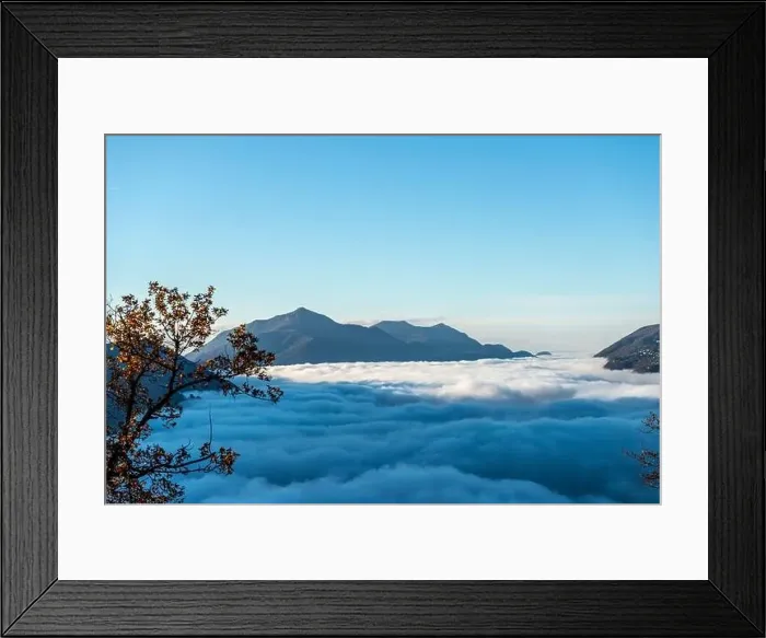 Framed Print : Mountain Range Above Cloudscape with Sunlight and Clear Sky in Lugano, Ticino in Switzerland Framed Print : Mountain Range Above Cloudscape with Sunlight and Clear Sky in Lugano, Ticino in Switzerland