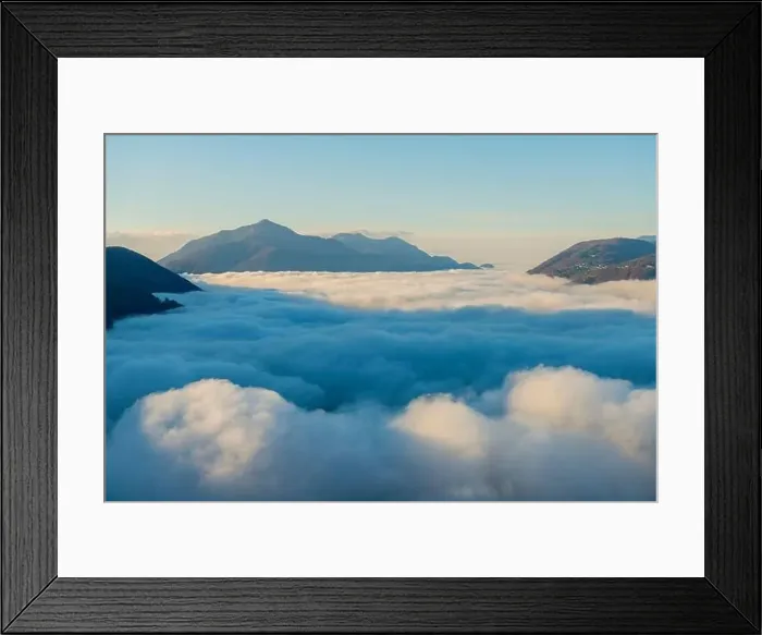 Framed Print : Mountain Peak Above Cloudscape with Sunlight and Clear Sky in Lugano, Ticino in Switzerland Framed Print : Mountain Peak Above Cloudscape with Sunlight and Clear Sky in Lugano, Ticino in Switzerland
