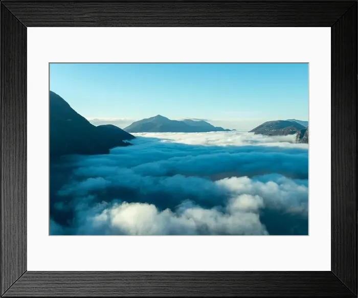 Framed Print : Mountain Peak Above Cloudscape with Sunlight and Clear Sky in Lugano, Ticino in Switzerland Framed Print : Mountain Peak Above Cloudscape with Sunlight and Clear Sky in Lugano, Ticino in Switzerland