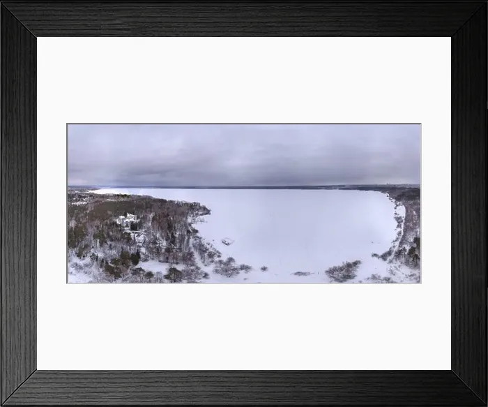 Framed Print : Snow-covered forest on lake shore with ice at sunset and the city on horizon Framed Print : Snow-covered forest on lake shore with ice at sunset and the city on horizon
