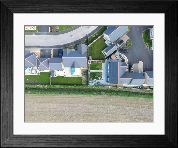 Framed Print : Drone top down view of detached bungalows seen at a new housing development in the English countryside Framed Print : Drone top down view of detached bungalows seen at a new housing development in the English countryside