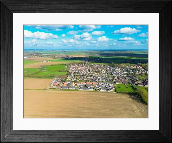 Framed Print : Drone view of a new housing estate showing detached bungalows in a rural location in Cambridgeshire, UK