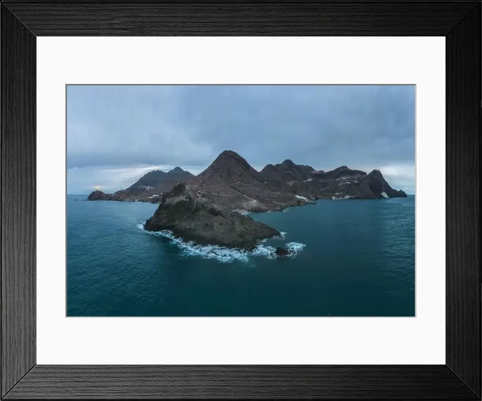 Framed Print : Drone view of lighthouse located on rough cliff near sea under cloudy sky in Almeria Framed Print : Drone view of lighthouse located on rough cliff near sea under cloudy sky in Almeria