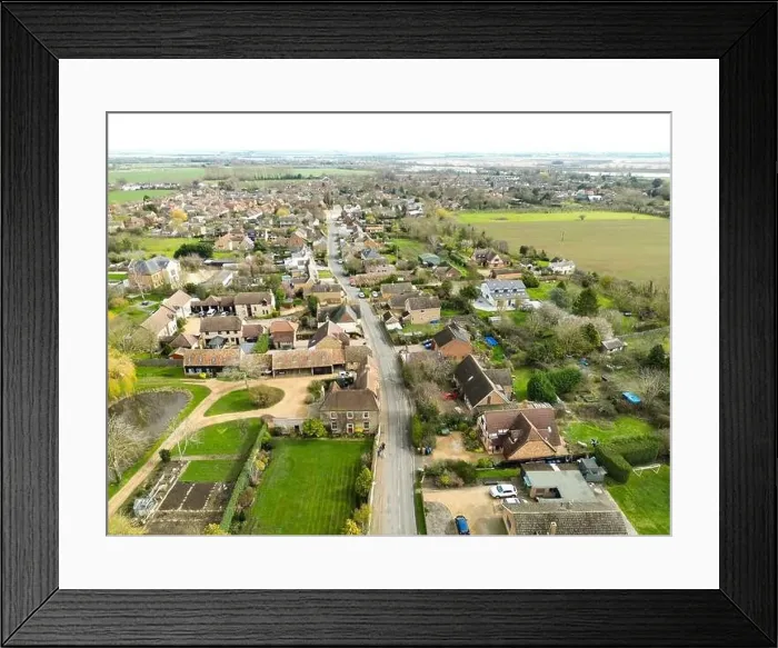 Framed Print : Drone view of a sprawling East Anglian village showing the main roadway leading through the bottom of the image Framed Print : Drone view of a sprawling East Anglian village showing the main roadway leading through the bottom of the image