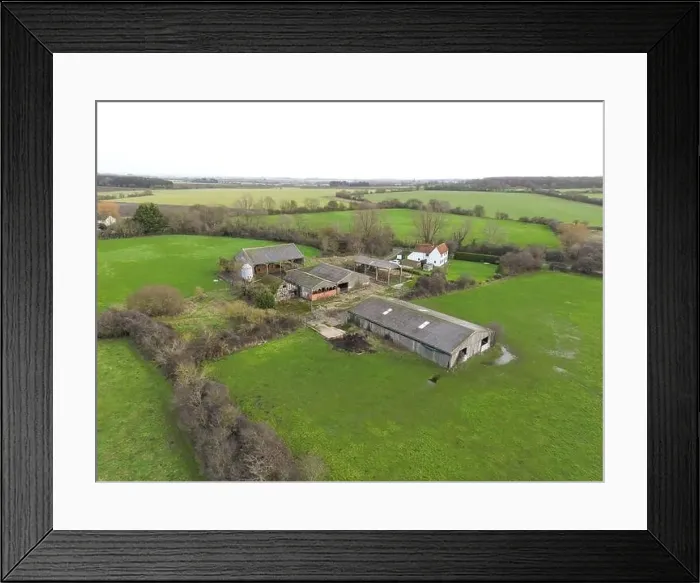 Framed Print : Drone view of a derelict dairy farm showing the cow sheds and grain hopper. The white farm building is still in use Framed Print : Drone view of a derelict dairy farm showing the cow sheds and grain hopper. The white farm building is still in use