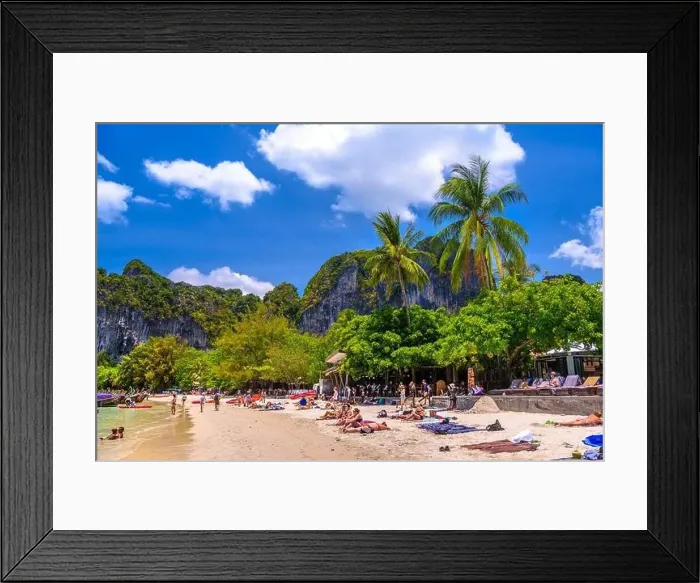 Framed Print : KRABI, THAILAND- MARCH 2018: People sunbathing among coconut palms on Railay beach west, Ao Nang, Krabi, Thailand Framed Print : KRABI, THAILAND- MARCH 2018: People sunbathing among coconut palms on Railay beach west, Ao Nang, Krabi, Thailand