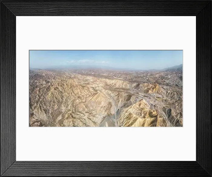Framed Print : Aerial view of rough rugged mounts with uneven surface forming natural valley Framed Print : Aerial view of rough rugged mounts with uneven surface forming natural valley