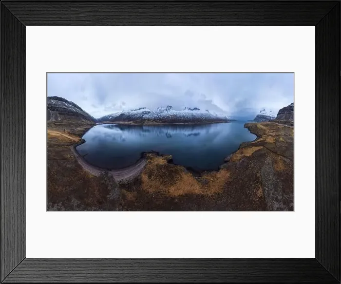Framed Print : Aerial view of pond surrounded by snowy mountains located under cloudy sky in Iceland during daytime Framed Print : Aerial view of pond surrounded by snowy mountains located under cloudy sky in Iceland during daytime