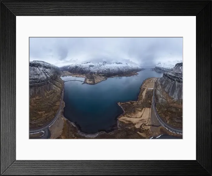 Framed Print : Aerial view of sea surrounded by snowy mountains located under cloudy sky in Iceland during daytime Framed Print : Aerial view of sea surrounded by snowy mountains located under cloudy sky in Iceland during daytime