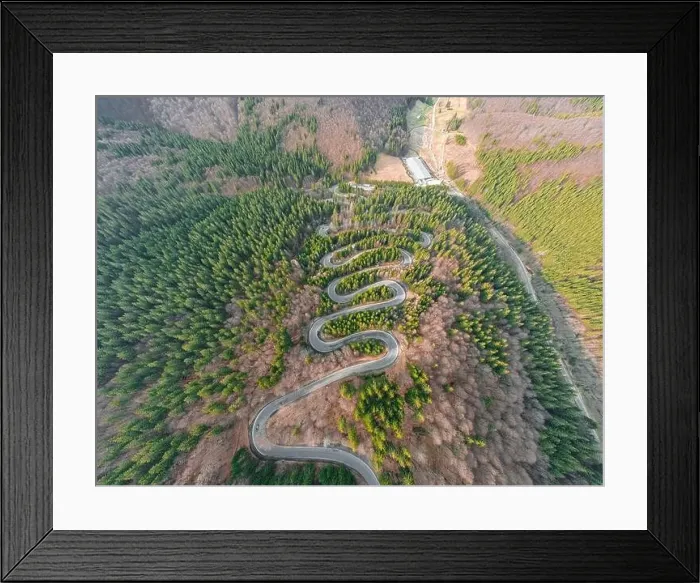 Framed Print : Aerial photography of a winding road in the mountains with serpentines and curves Framed Print : Aerial photography of a winding road in the mountains with serpentines and curves