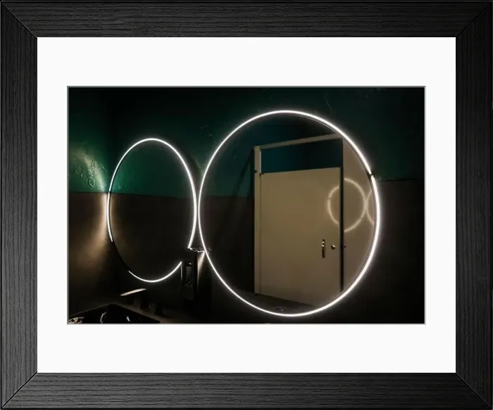 Framed Print : Large round mirror with lights in a downtown bar restroom Framed Print : Large round mirror with lights in a downtown bar restroom