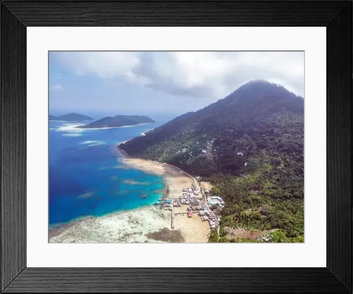 Framed Print : Indonesia Anambas Islands - Drone view Telaga Island coast line with village and vulcano Framed Print : Indonesia Anambas Islands - Drone view Telaga Island coast line with village and vulcano