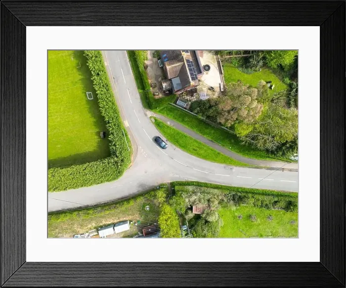 Framed Print : Drone top down view of a dangerous bend and road junction in rural England Framed Print : Drone top down view of a dangerous bend and road junction in rural England