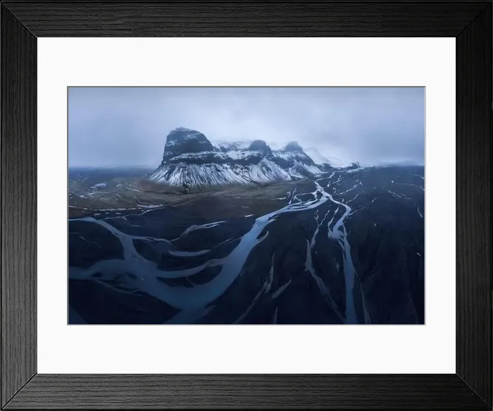 Framed Print : Drone view of magnificent rocky snowy Lomagnupur Mountain slope in cloudy sunset sky in Iceland Framed Print : Drone view of magnificent rocky snowy Lomagnupur Mountain slope in cloudy sunset sky in Iceland