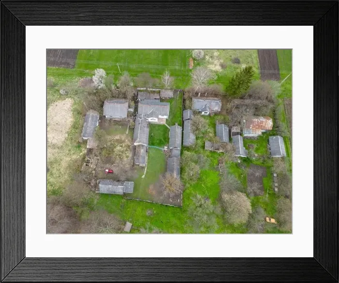 Framed Print : Top view of gray roofs of houses among green grass, Ukrainian village Framed Print : Top view of gray roofs of houses among green grass, Ukrainian village