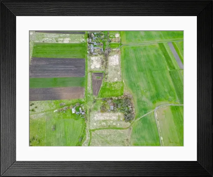Framed Print : Drone footage captures a vibrant green field bordered by a dense thicket of trees. Rural spring scene Framed Print : Drone footage captures a vibrant green field bordered by a dense thicket of trees. Rural spring scene
