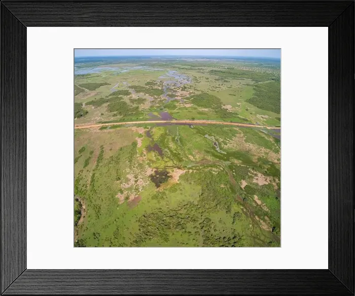 Framed Print : Aerial view of Transpantaneira dirt road crossing a lagoon over a small bridge in the typical landscape of North Framed Print : Aerial view of Transpantaneira dirt road crossing a lagoon over a small bridge in the typical landscape of North