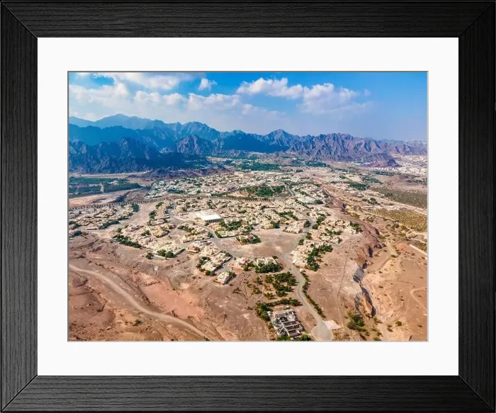 Framed Print : Hatta town aerial cityscape surrounded by Hajar mountains in Hatta enclave of Dubai in the United Arab Emirates aerial Framed Print : Hatta town aerial cityscape surrounded by Hajar mountains in Hatta enclave of Dubai in the United Arab Emirates aerial